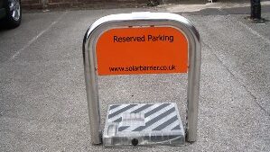 Solar powered parking bay barrier with personalised plate