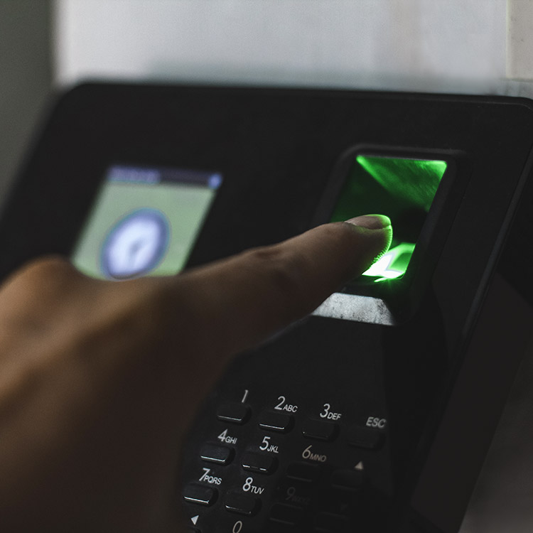 Person using a fingerprint scanner to access a room