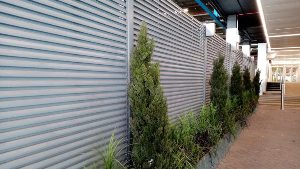 Louvered fence wall with planters