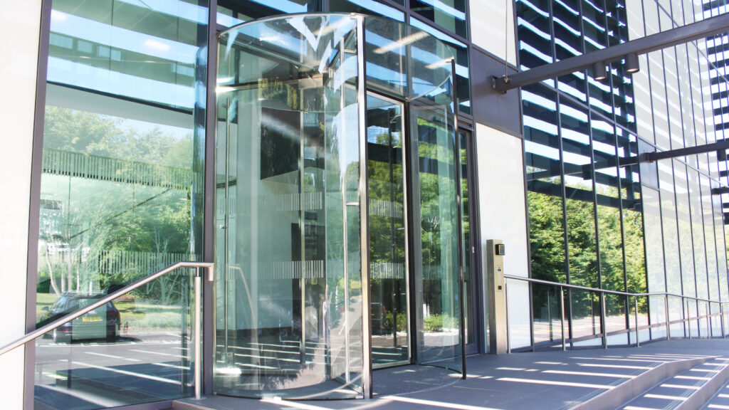 Automatic revolving glass door on modern office building