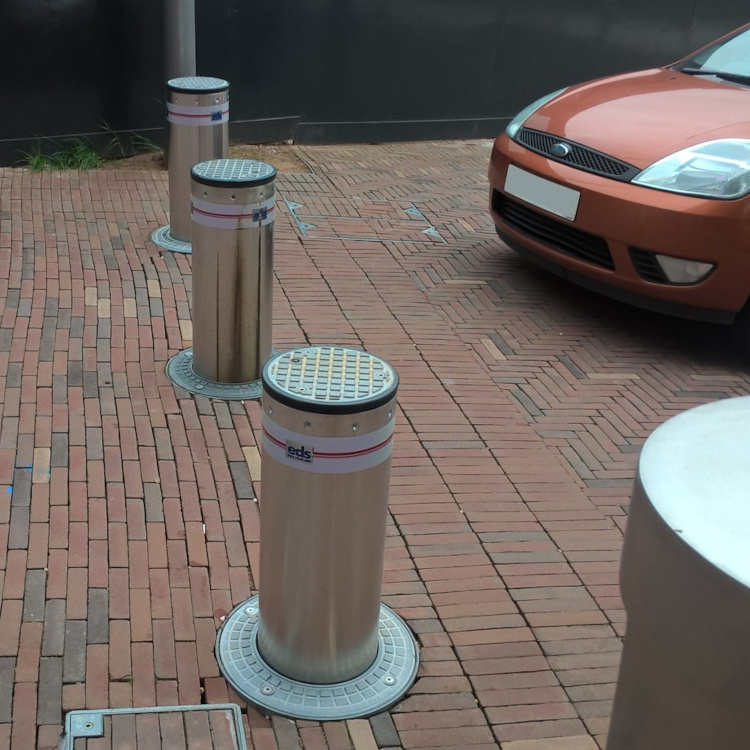Photo of automatic rising bollards blocking access to a private car park