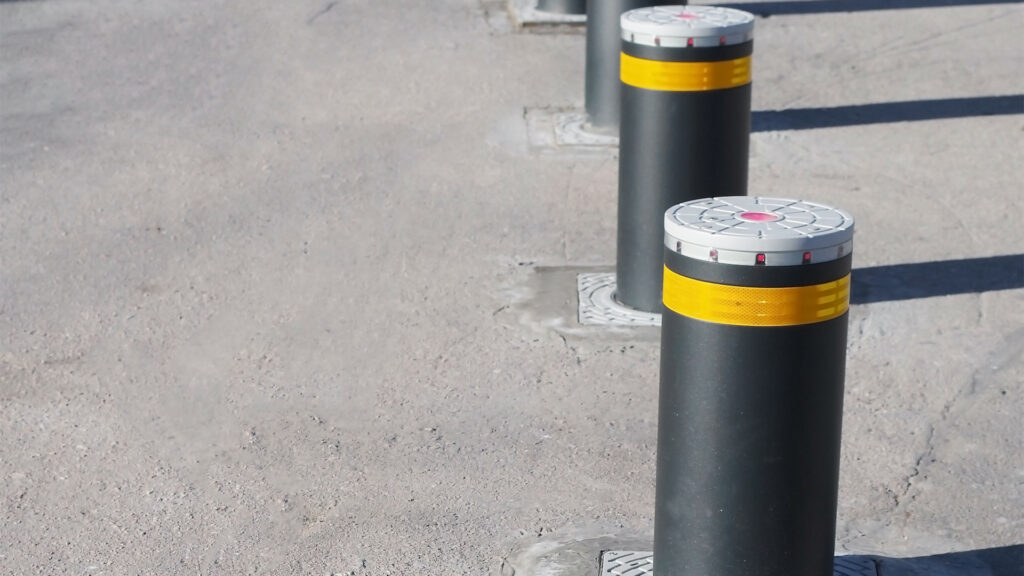 Automatic crash rated bollards on a road