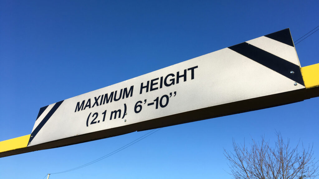 "Maximum height 2.1m" sign on a barrier