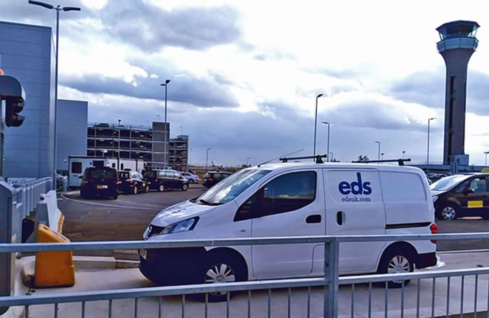 EDS van parked in front of control twoer at London Luton Airport