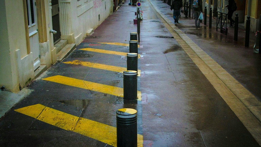 Retractable bollards on side of road